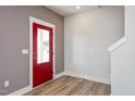 Bright entryway with red door and hardwood floors at 912 Allen Park Dr, Raleigh, NC 27604