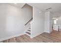 Modern staircase with hardwood floors and white walls at 912 Allen Park Dr, Raleigh, NC 27604
