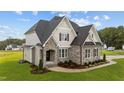 Two-story house with stone and siding, showcasing a welcoming entrance at 25 Cotton Fields Ln # 29, Fuquay Varina, NC 27526
