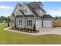 Charming home with three-car garage and manicured lawn at 25 Cotton Fields Ln # 29, Fuquay Varina, NC 27526