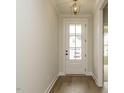 Bright foyer with hardwood floors, white walls, stylish pendant lighting, and front door with glass panels at 205 Wash Hollow Dr, Wendell, NC 27591