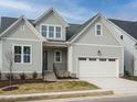 Two-story Craftsman home with gray siding, white trim, and a two-car garage at 205 Wash Hollow Dr, Wendell, NC 27591