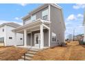 Home's backyard features neutral siding, white trim, and a covered porch with steps to the yard at 9301 Kitchin Farms Way # 433, Wake Forest, NC 27587