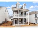 Beautiful two-story home featuring a covered porch with white columns and black shutters at 9301 Kitchin Farms Way # 433, Wake Forest, NC 27587
