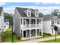 Two-story home boasts a charming front porch, providing an inviting curb appeal at 9301 Kitchin Farms Way # 433, Wake Forest, NC 27587