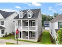 Charming two-story home with a welcoming front porch, dormer windows and manicured lawn at 9301 Kitchin Farms Way # 433, Wake Forest, NC 27587