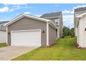Detached two car garage with white garage door and gray siding at 9301 Kitchin Farms Way # 433, Wake Forest, NC 27587