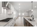 Modern kitchen featuring stainless steel appliances, granite countertops, and a spacious open layout at 9301 Kitchin Farms Way # 433, Wake Forest, NC 27587