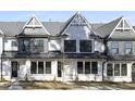 Beautiful townhome showcasing gabled roof accents, complemented by well-maintained landscaping at 320 Church St, Morrisville, NC 27560
