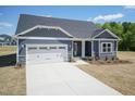 Beautiful home with a well-maintained front yard, long driveway, and attached two-car garage at 157 Newport Landing # 95, Garner, NC 27529