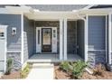 Inviting front entry with stone accents and glass front door for a modern appeal at 157 Newport Landing # 95, Garner, NC 27529