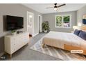 Serene bedroom with a large window, minimalist decor, and an en-suite bathroom at 1432 Quarter Pt, Raleigh, NC 27615
