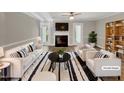 Bright and airy living room featuring a fireplace, modern furniture, and stylish decor; perfect for relaxing or entertaining at 1432 Quarter Pt, Raleigh, NC 27615