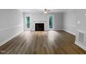 Spacious living room features hardwood floors, fireplace, and a ceiling fan at 1432 Quarter Pt, Raleigh, NC 27615