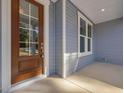 Inviting entryway featuring a beautiful glass front door with sidelights and classic light blue siding at 146 Wood Wedge, Sanford, NC 27332