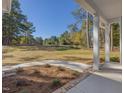Inviting front yard features a lush green lawn and mature trees providing a sense of privacy at 146 Wood Wedge, Sanford, NC 27332