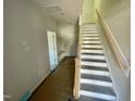 A newly built entryway showcases stairs, a door, and a bench area at 3006 Freewinds Way # 41, Cary, NC 27519