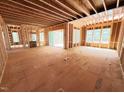 Spacious, unfinished room with exposed wood framing and large windows filling the space with light at 111 Gaines Trail, Pittsboro, NC 27312