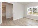 Bright bedroom with a large window and light wood floors, creating a serene and inviting space at 136 Newport Lndg, Garner, NC 27529