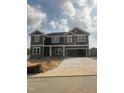New two-story home showcasing a spacious two-car garage and stone facade at 136 Newport Lndg, Garner, NC 27529