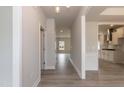 Open hallway with wood floors, leading to a modern kitchen and inviting living spaces enhancing the home's flow at 136 Newport Lndg, Garner, NC 27529