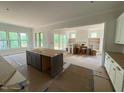 Spacious kitchen featuring a central island, ample counter space, and natural light from large windows at 162 Gaines Trail, Pittsboro, NC 27312