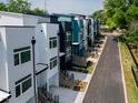 Modern townhome exterior featuring a sleek design with multi-tone color schemes along with green grass and a newly paved road at 602 Rocky Knob Ct, Raleigh, NC 27601