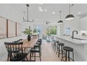 Bright, open-concept living space with hardwood floors and modern lighting is connected to the kitchen and dining area at 610 Rocky Knob Ct, Raleigh, NC 27601