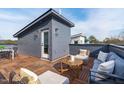 Relax on this expansive rooftop deck with stylish outdoor furniture and privacy fencing at 610 Rocky Knob Ct, Raleigh, NC 27601