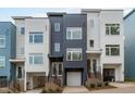 Contemporary townhome exterior showcasing modern design, garage, and inviting entrance with sleek stairs at 614 Rocky Knob Ct, Raleigh, NC 27601