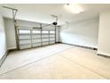 Spacious two-car garage with smooth concrete flooring and white door at 156 Southern Estates Dr, Sanford, NC 27330