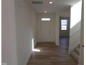 Bright entryway showcasing wood-look flooring and a view into the home's open-concept living space at 39 Longdale Dr, Graham, NC 27253