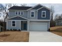 Charming two-story home with light gray siding, blue accents, and a spacious two-car garage at 39 Longdale Dr, Graham, NC 27253