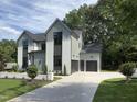 Lovely house with a concrete driveway and two-car garage at 5208 Knollwood Rd, Raleigh, NC 27609