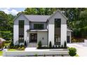 Stunning exterior of home, modern design with green lawn and manicured landscaping at 5208 Knollwood Rd, Raleigh, NC 27609