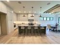 Bright kitchen boasts ample counter space, modern lighting, and an adjacent dining area at 5208 Knollwood Rd, Raleigh, NC 27609
