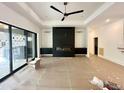 Bright, spacious living room with modern fireplace, sleek cabinets, and large windows for ample natural light at 5208 Knollwood Rd, Raleigh, NC 27609