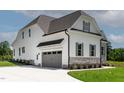 Spacious two-story home with a gray garage door, white siding, and well-maintained landscaping at 55 Harvest View Way, Franklinton, NC 27525