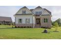 Striking new construction home showcasing a lush green lawn and inviting facade at 55 Harvest View Way, Franklinton, NC 27525