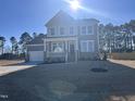 Well-maintained two-story house boasts a welcoming front porch, two-car garage, and manicured lawn at 117 Shelby Meadow Ln, Angier, NC 27501