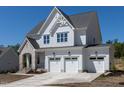 Charming two-story home with a three-car garage, well-maintained lawn, and classic white siding at 6048 Scalybark Rd, Durham, NC 27712
