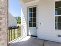 The covered front porch features a light blue front door and a wrought iron railing at 6048 Scalybark Rd, Durham, NC 27712