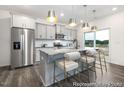 Modern kitchen with gray cabinets, granite countertops, and stainless steel appliances at 144 Benson Village Dr # 81P, Benson, NC 27504