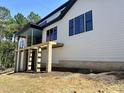 Exterior view highlighting the home's siding, brick foundation, and a covered porch at 37 Green Turtle Ln, Pittsboro, NC 27312
