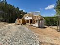 New home under construction with framing, sheathing, and roof trusses at 37 Green Turtle Ln, Pittsboro, NC 27312