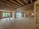 Spacious living room under construction with a fireplace and large sliding glass doors to the backyard at 37 Green Turtle Ln, Pittsboro, NC 27312