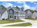 Charming two-story home with a welcoming front porch and attached two car garage at 9140 Dupree Meadow Dr # 9, Angier, NC 27501
