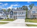 Charming two-story home with a welcoming front porch and attached two car garage at 9140 Dupree Meadow Dr # 9, Angier, NC 27501