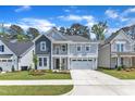 Charming two-story home with a welcoming front porch and attached two car garage at 9140 Dupree Meadow Dr # 9, Angier, NC 27501