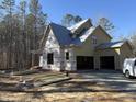 Under construction home with yellow siding and two car garage at 1317 Old Lystra Rd, Chapel Hill, NC 27517